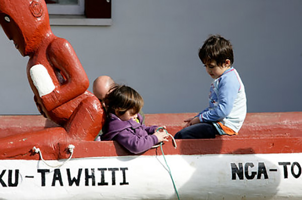 Two children playing in a waka